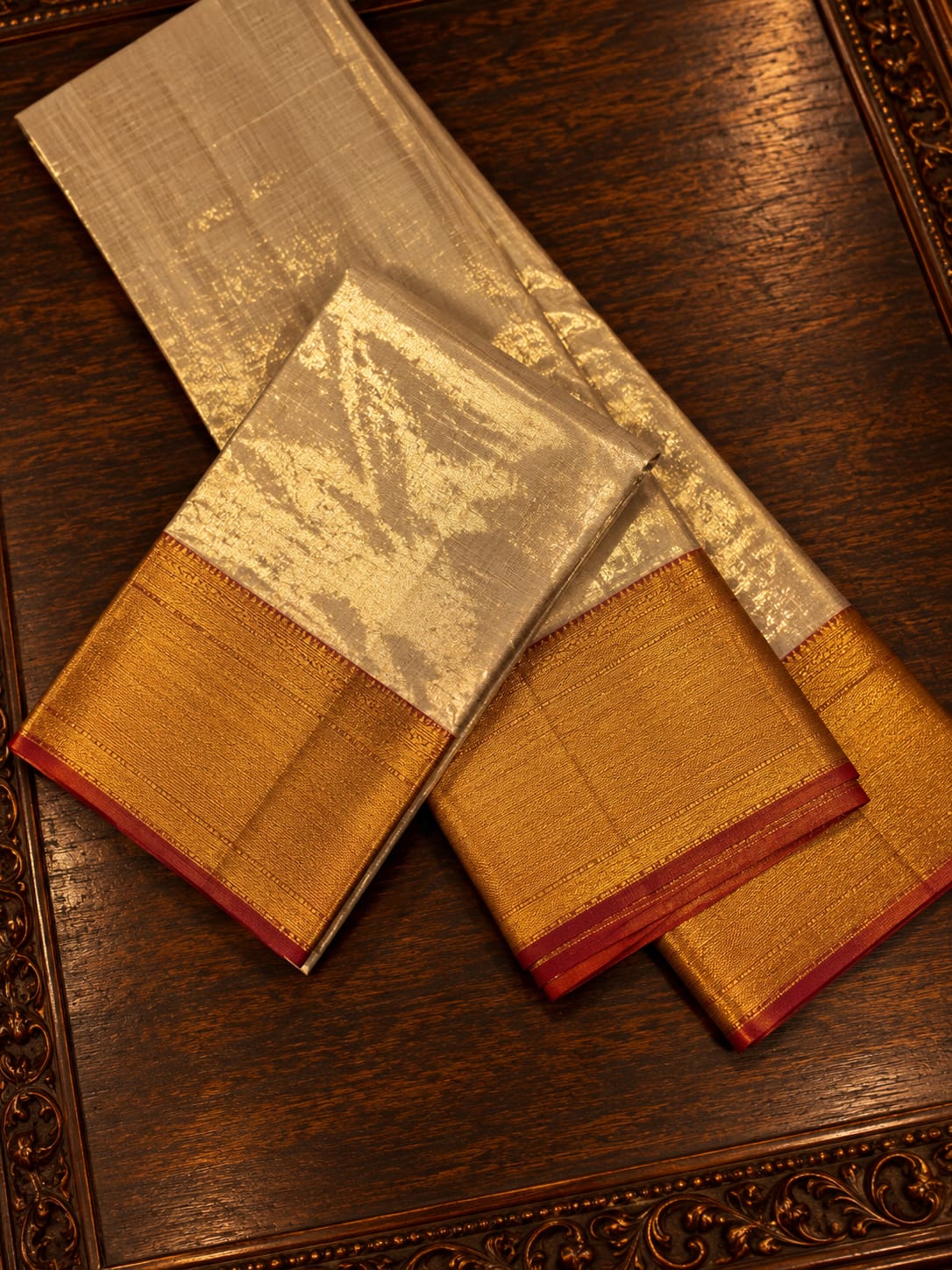 Luminous Silver-Grey Tissue Silk Traditional Dhothi Ensemble with All-Over Gold Zari Brocade & Contrast Red Border