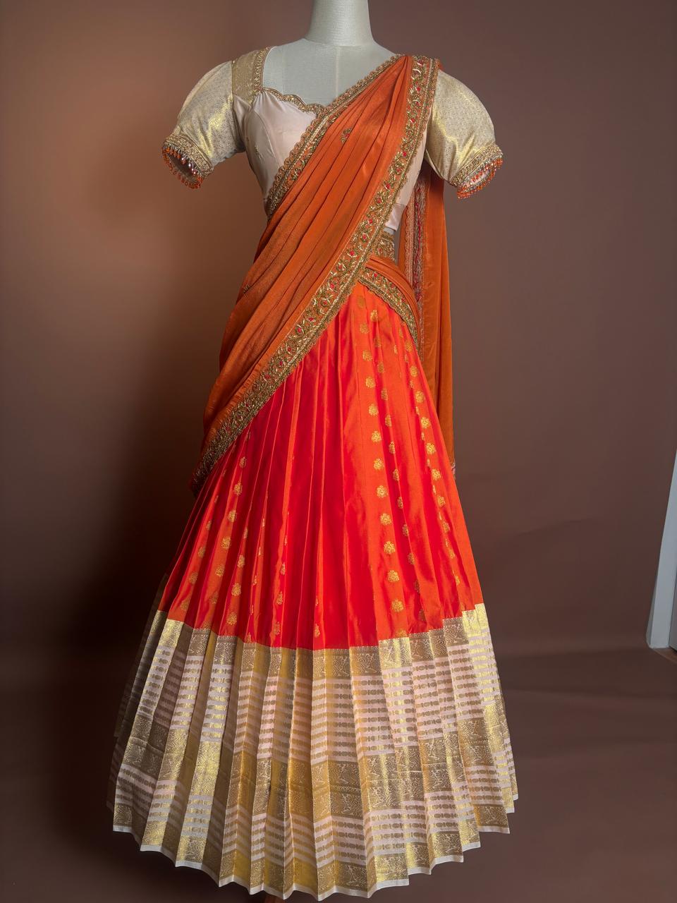 Vibrant Tangerine and Gold Silk Half-Saree (Langa Voni) with Intricate Zari Brocade and Beaded Zardozi Blouse
